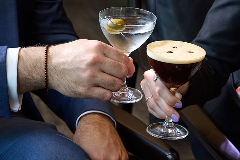 man and woman toasting with two willowsong cocktails